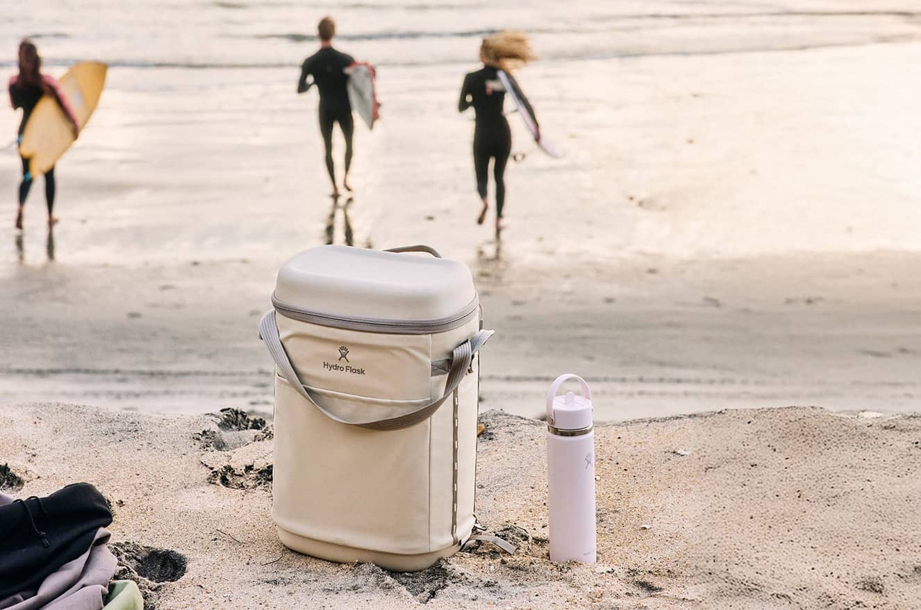 Insulated cooler and bottle on a beach