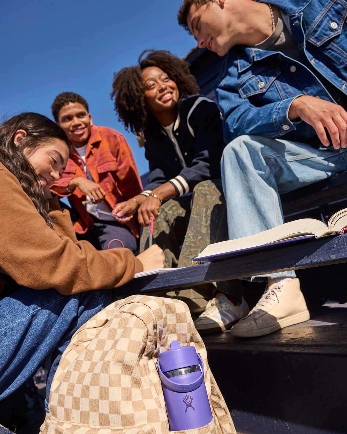 Friends with colorful backpacks and bottles